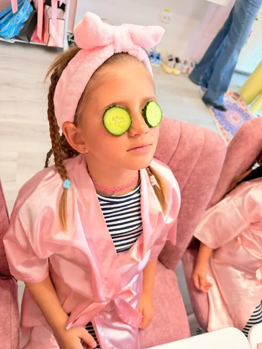 A smile with cucumber slices on the eyes
