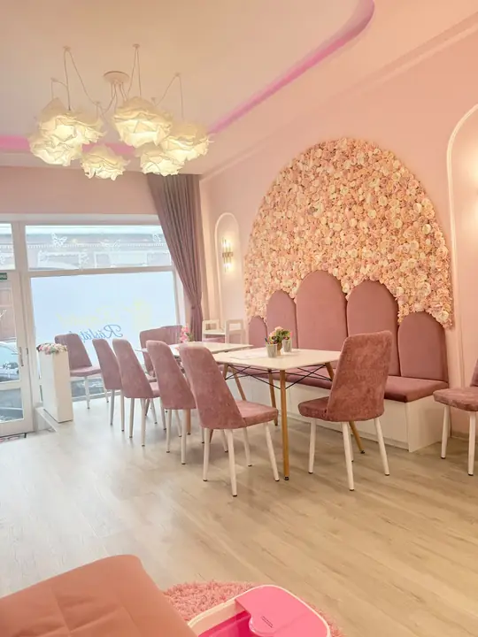 The rose arch with velvet chair backs and the flower-cloud ceiling